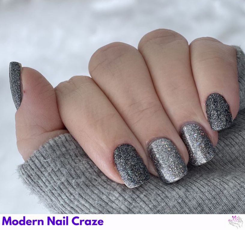 Gray nails covered in chunky silver glitter for a sparkling finish.