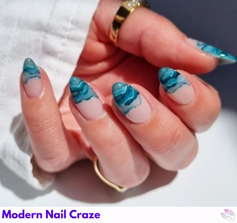 Watercolor mermaid nails with rolling ocean waves on a nude base.