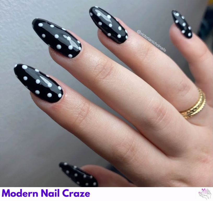 Dot accent almond nails with tiny dots near cuticles, subtle style.