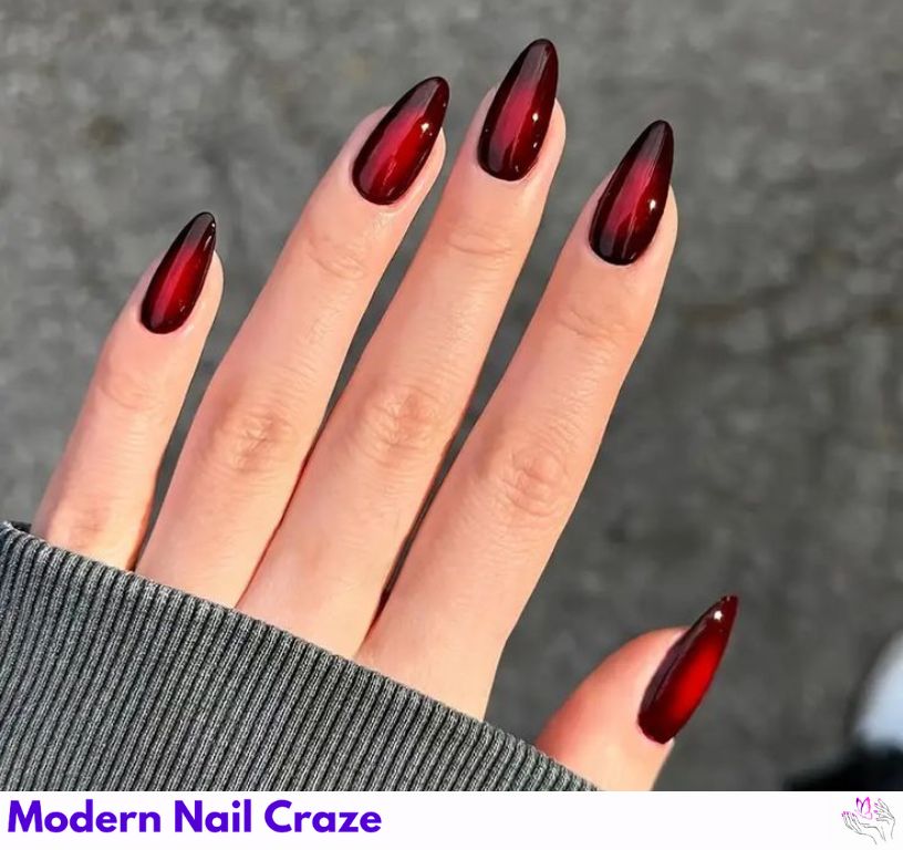 Glossy burgundy almond nails, dark red with high-shine top coat.