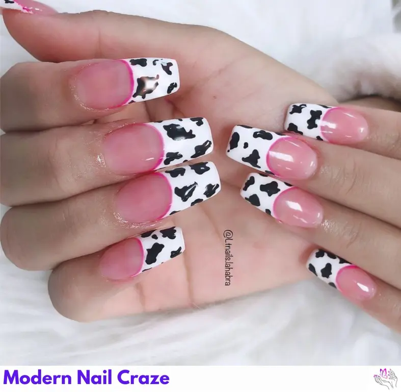 Quirky cow print on pinky nails for a playful and trendy look that stands out with unique charm.