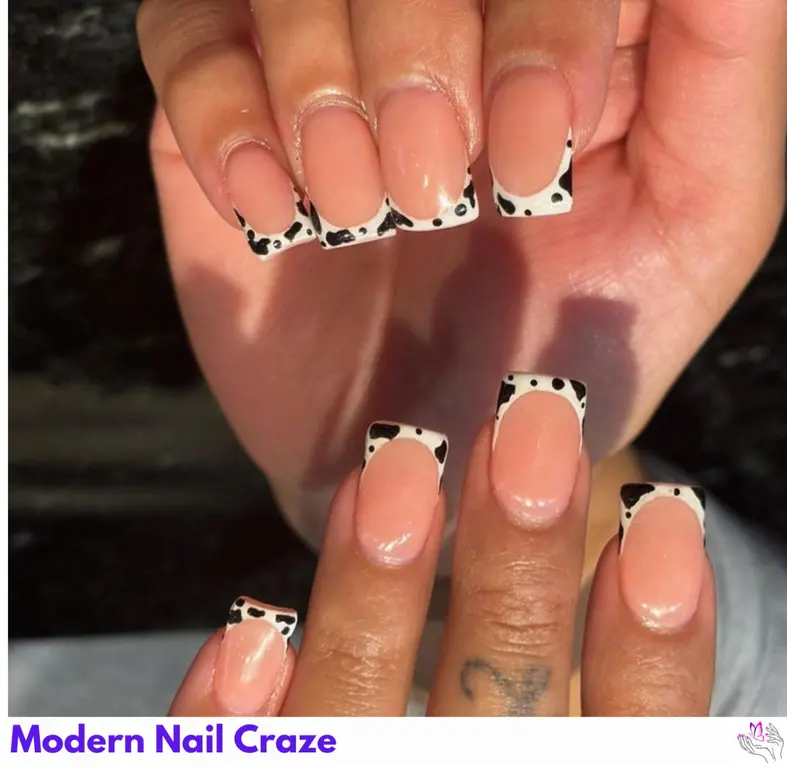 Creative cow print on French manicures, offering a fresh and fun twist on classic nails.