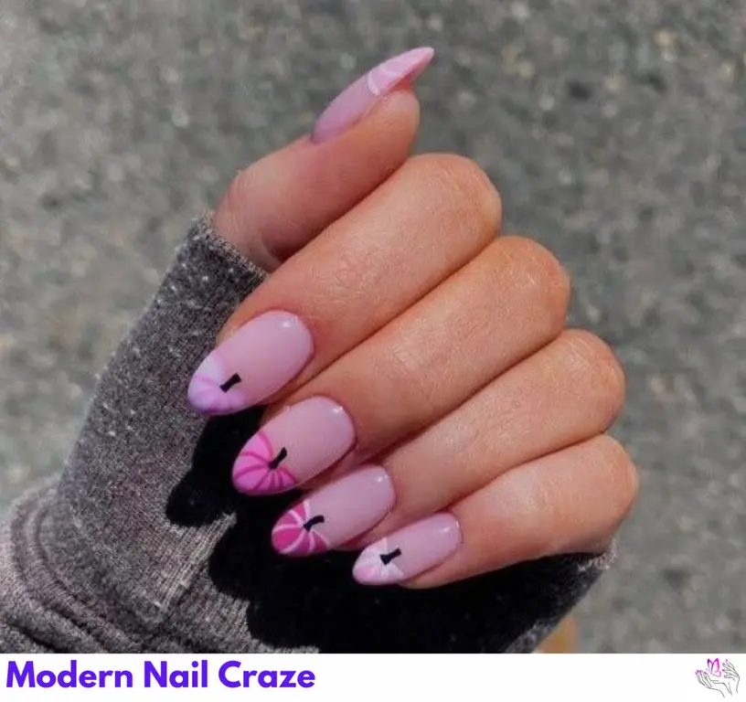 Adorable pumpkin design on short pink nails, ideal for a festive, fall-inspired manicure.