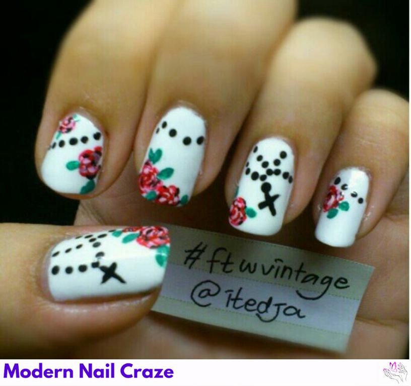 Floral cross nail art on short nails with delicate pastel flowers.