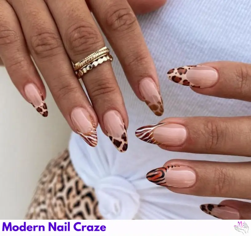 Gel French tips with jungle-inspired animal prints, offering a bold, stylish look.