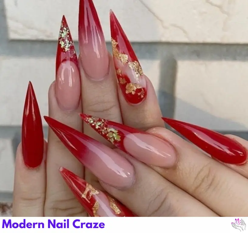 These glamorous long red nails feature a luxurious gold foil design for an elegant and chic look.