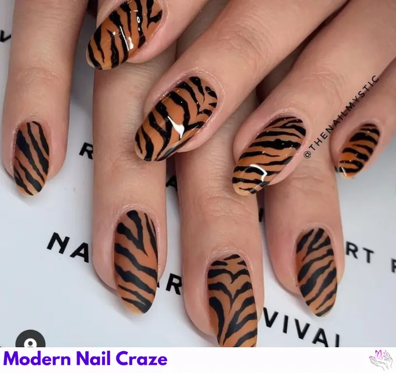 Neutral tiger print nails with intricate stripes, offering a wild yet polished look for a stylish manicure.