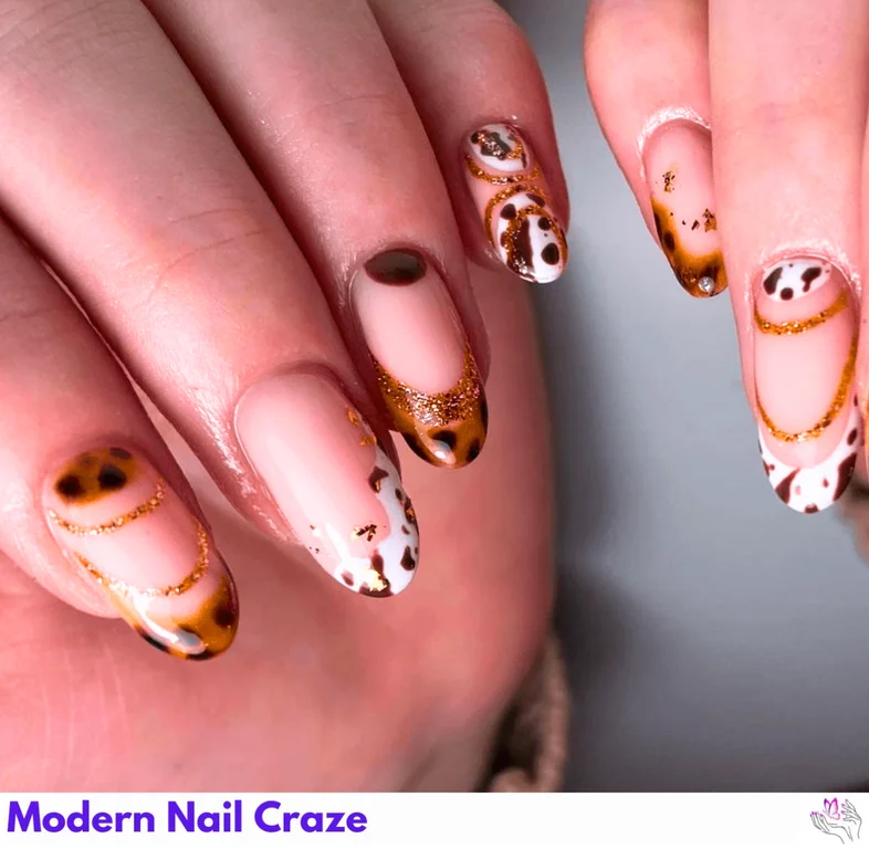 Tortoise and Cow Print Nails combine classic and modern styles with neutral tones for a chic, versatile look.