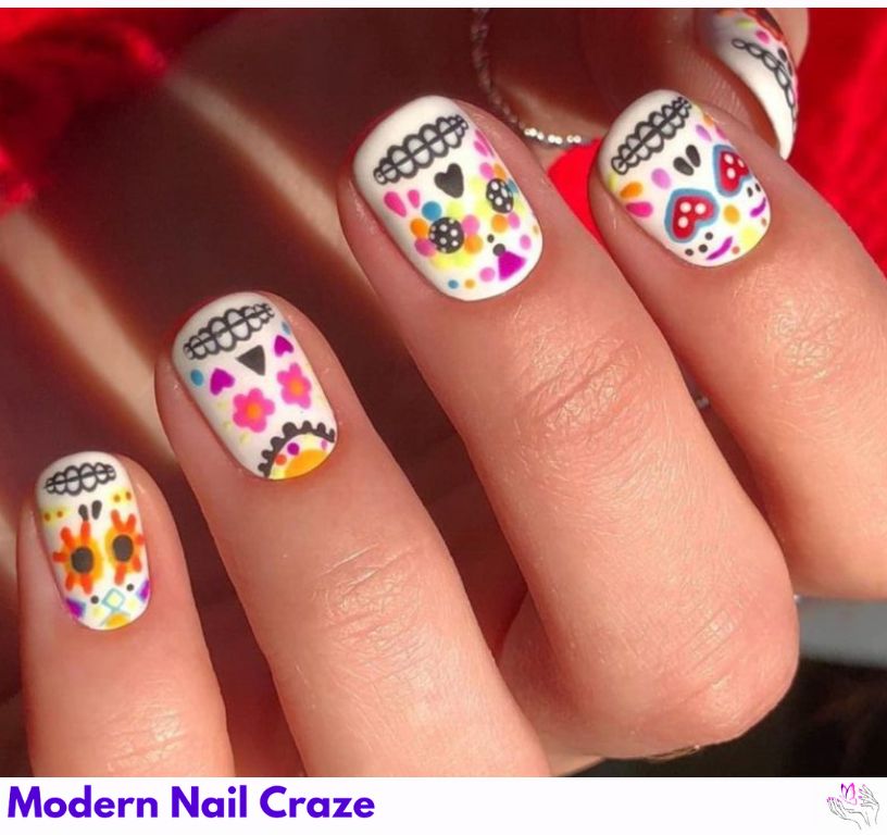 Colorful sugar skulls with floral accents on nails. 