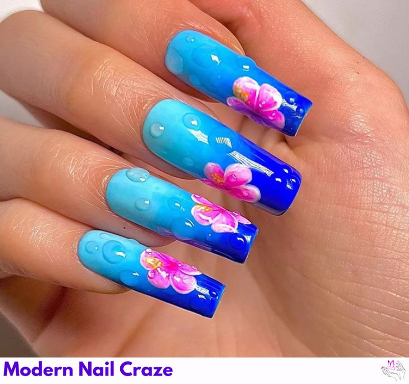 Fijian Flowers: Tropical blue ombré nails with pink hibiscus art.