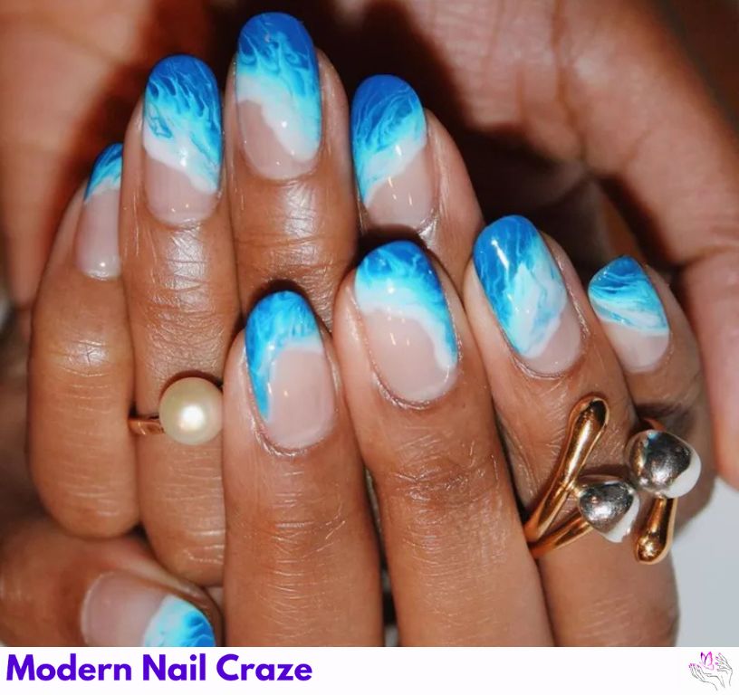 Elegant oceanic swirl nails with marbled tips.