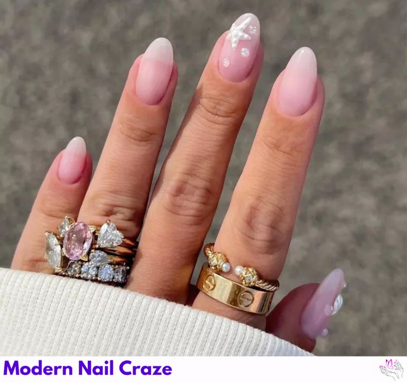 Minimal seashell nails with decals, pearls, and beads.