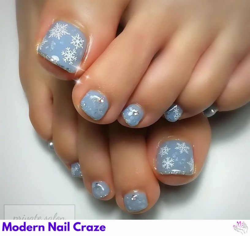 Delicate silver snowflake nails for a frosty winter look.