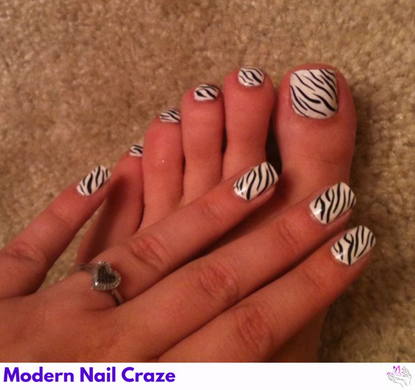 Bold zebra print nails with a monochromatic silver twist.