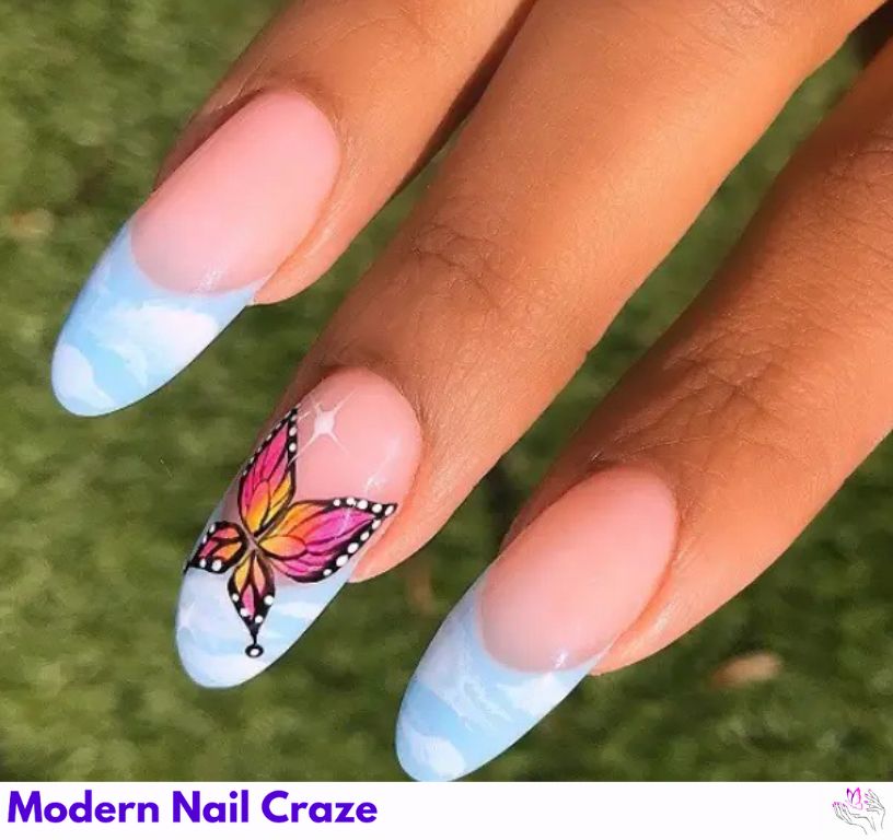 Soft blue French nails with dreamy clouds and butterflies.