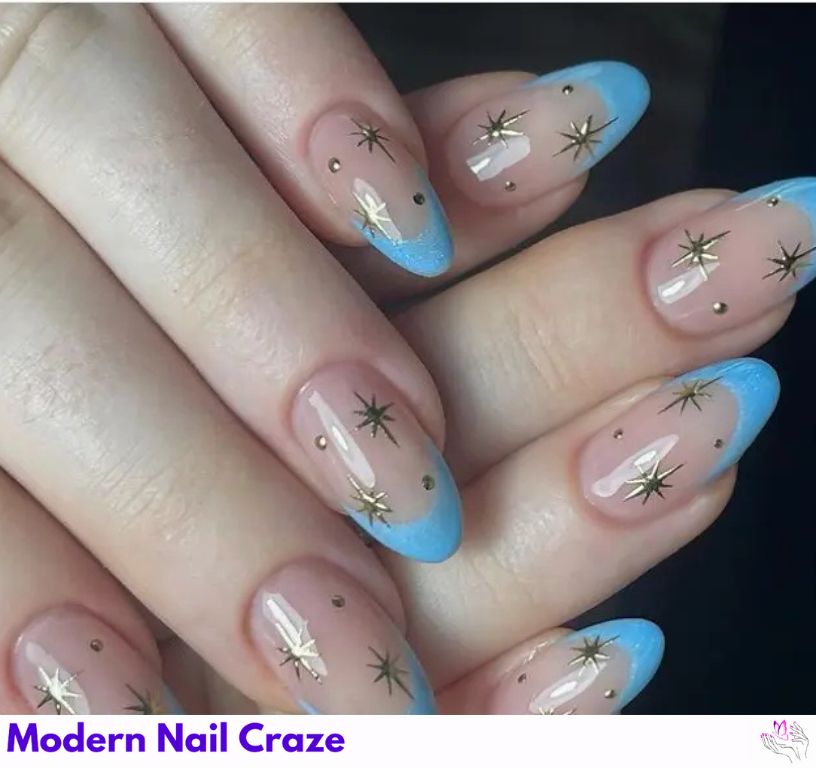 Stunning blue French nails with icy tones and gold star details.