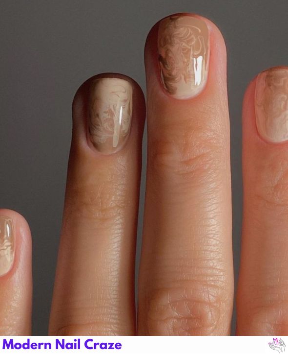 Neutral nails with soft, creamy latte swirl designs.