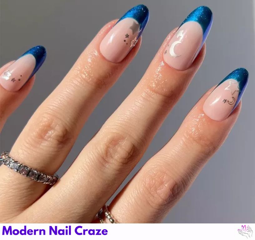 Moody and magical blue French nails with dark, elegant tones.