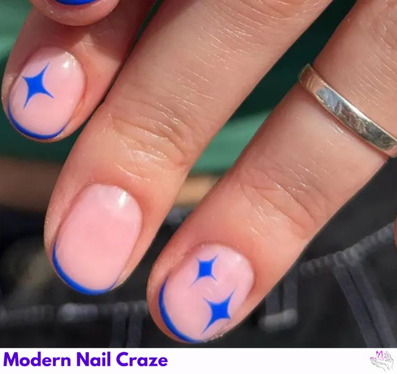 Elegant blue French nails with royal tones and star details.