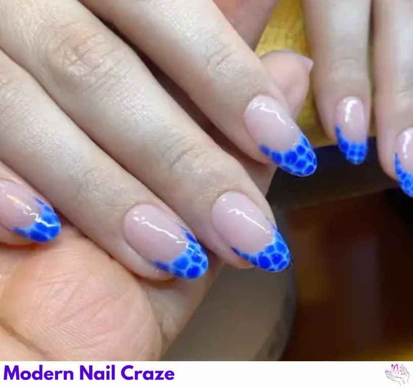 Chic croc-print blue French nails for a stylish manicure.