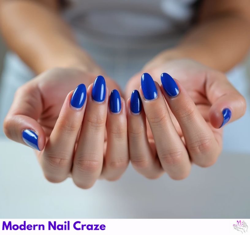 Luxurious Almond blue French nails with a rich royal blue touch.
