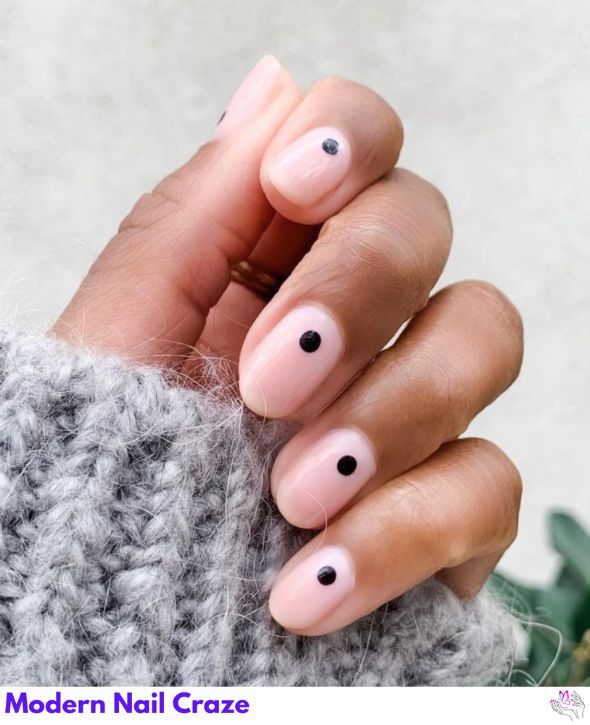 Minimalist nails with a single black dot accent.