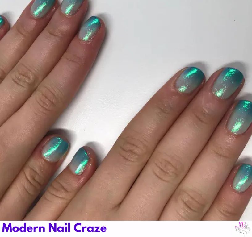 Shimmering turquoise blue French nails with an ombré glitter finish.