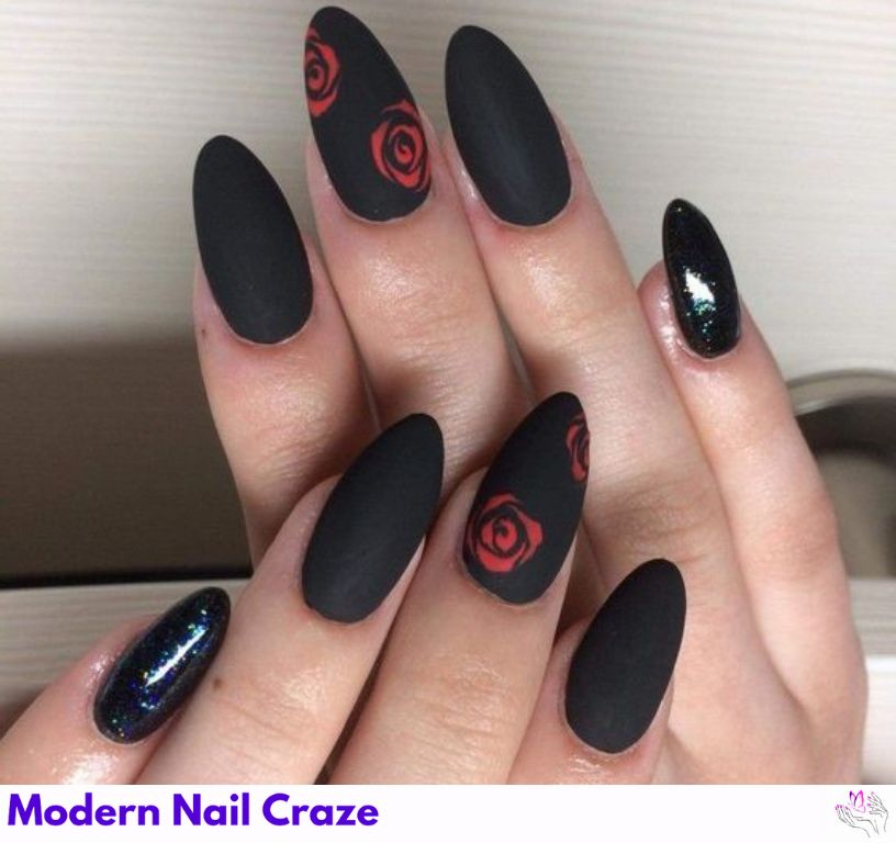 Nude nails with matte black nails with design featuring floral detailing.
