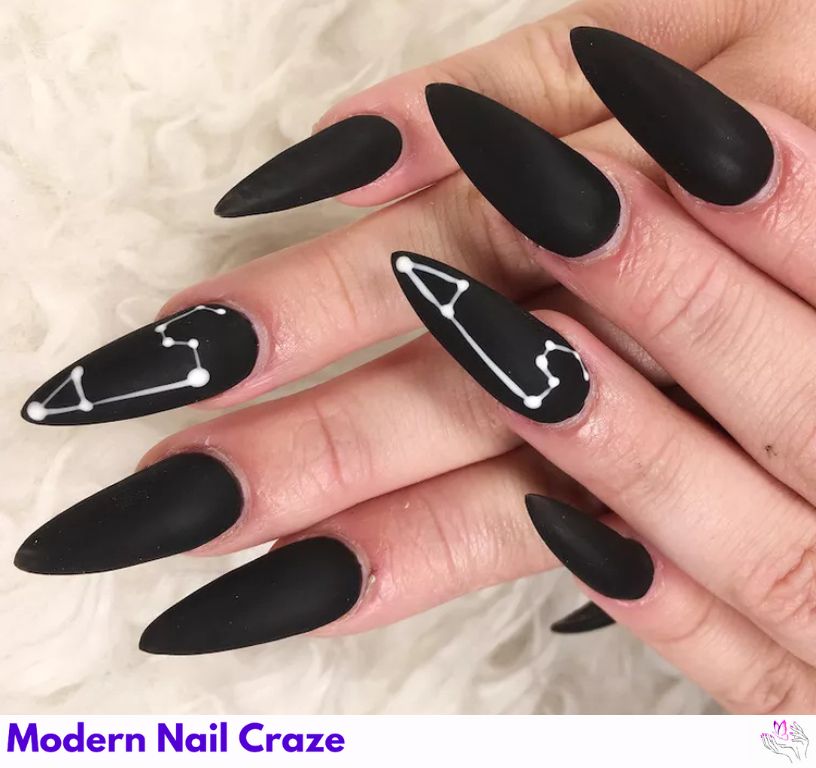Zodiac-inspired matte black nails with design honoring astrology.