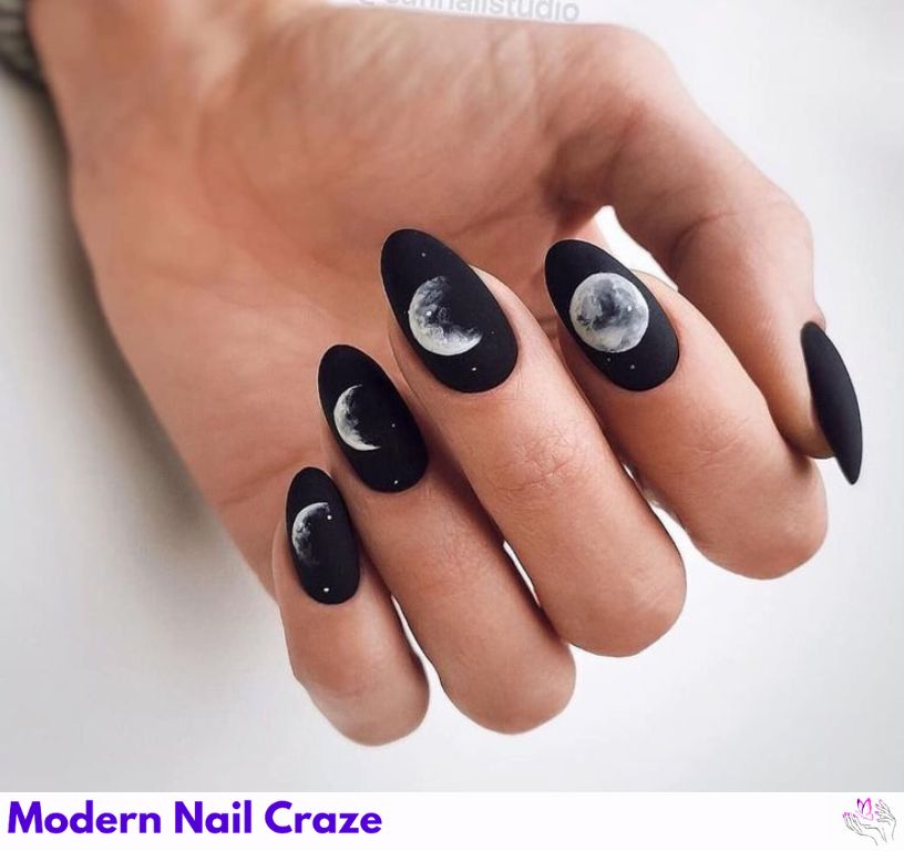 Astrology-themed matte black nails with design featuring a moon.