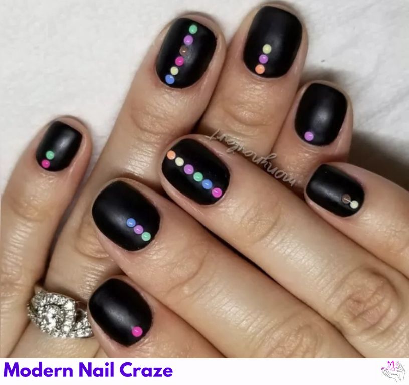 Playful matte black nails with design with neon dot patterns.