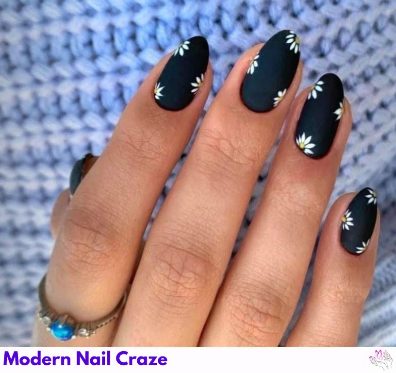 Floral-inspired matte black nails with design perfect for summer.