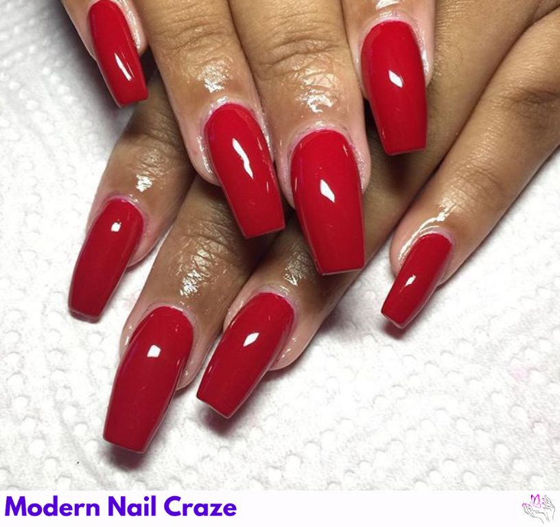 Short nails painted in deep burgundy with gold line accents, perfect vintage-inspired style.