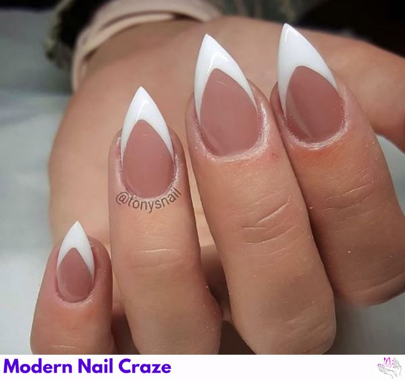 Classic French tip short stiletto nails with sharp white tips.