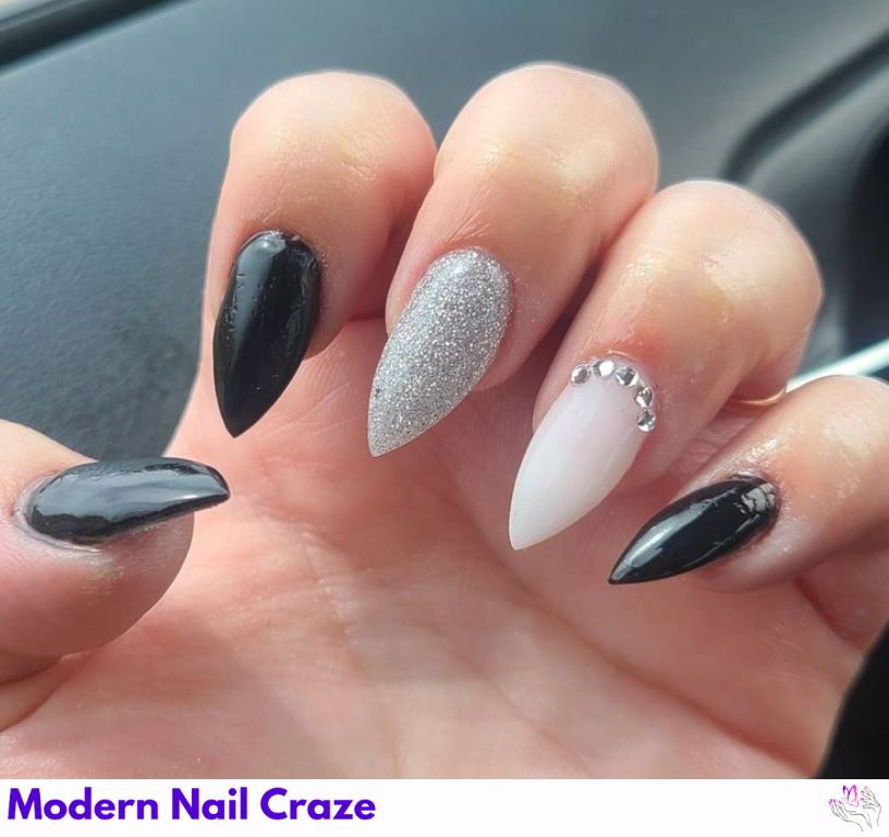 Sparkly rhinestone embellishments on short stiletto nails for special events.