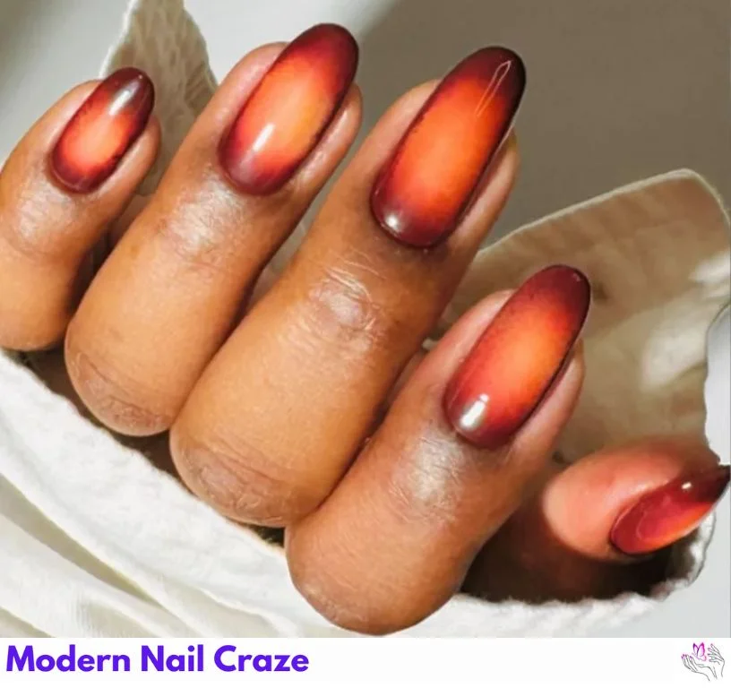 Amber aura nails with burnt orange glow and soft center gradient.