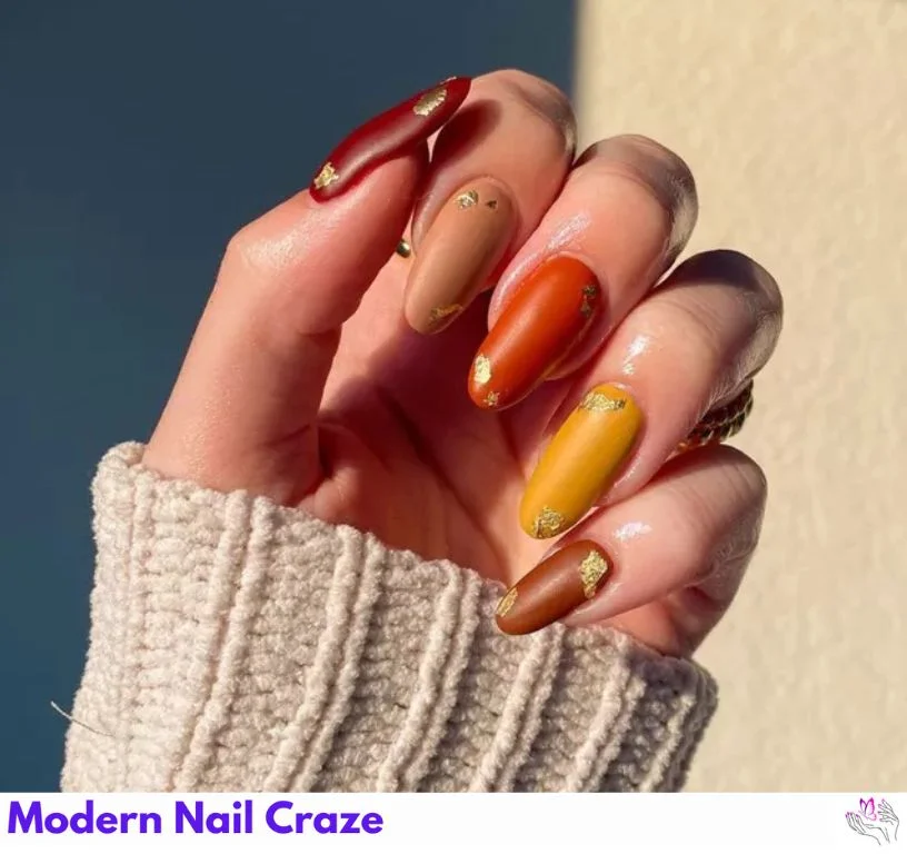 Brick orange nails with bronze geometric accents — an elegant fall nail idea.