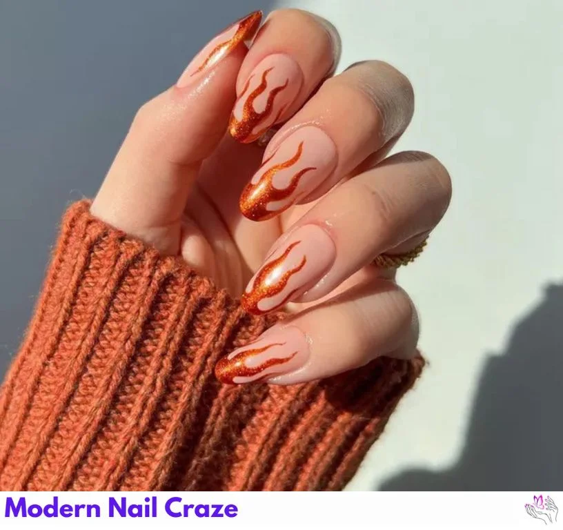 Burnt orange ember nails with shimmer and bronze foil tips — fire-inspired manicure.