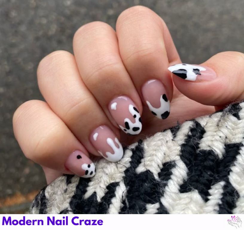 Minimalist cow print micro-tip nails on a long almond-shaped manicure.