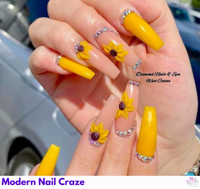 Sunflower nail art featuring crystal embellishments on an ombré background