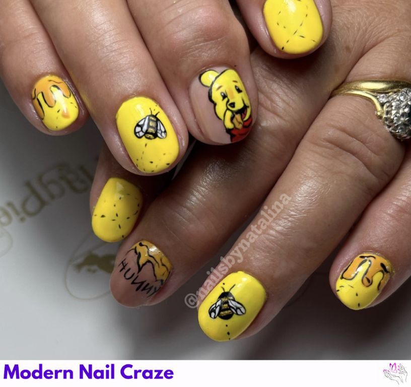 Cute Winnie the Pooh Nail Art – Smiling Pooh faces, honey pots, and buzzing bees on pastel nails.