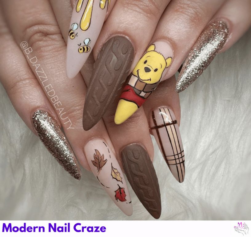Fall Disney Pooh Nails – Orange and brown fall nails with Pooh in scarves and leaves.