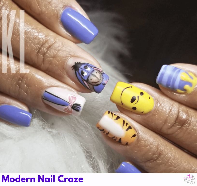 Eeyore, Tigger, and Pooh Nails – Trio-themed nail art with each character on a separate finger in soft yellow, orange, and gray tones.