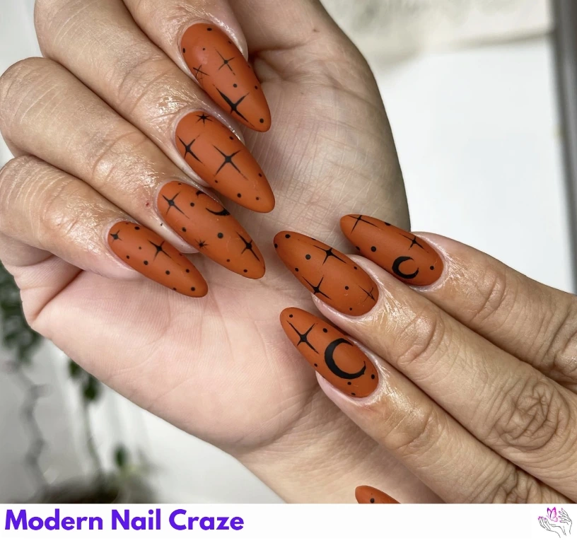 Long matte burnt orange nails with leopard print and animal patterns.