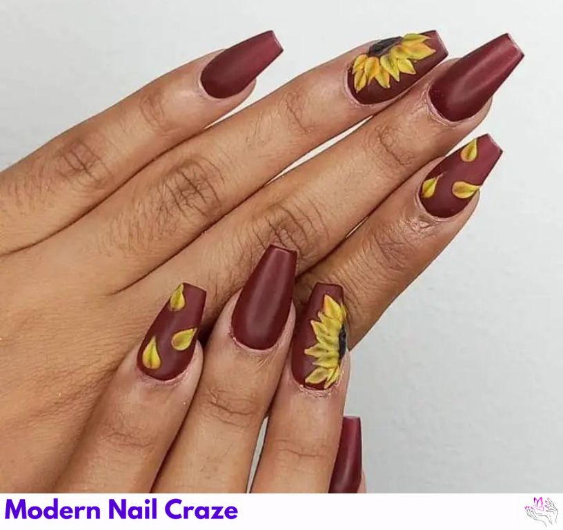 Autumn-inspired sunflower nail design with taupe base and warm yellow flowers
