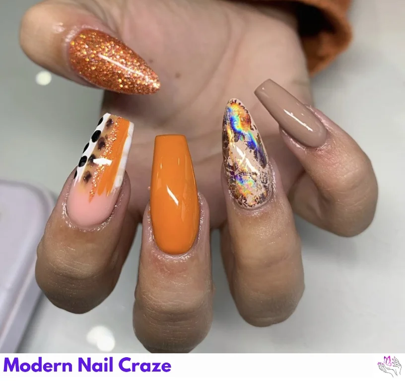 Burnt orange nails with abstract glitter and metallic fall-themed designs.