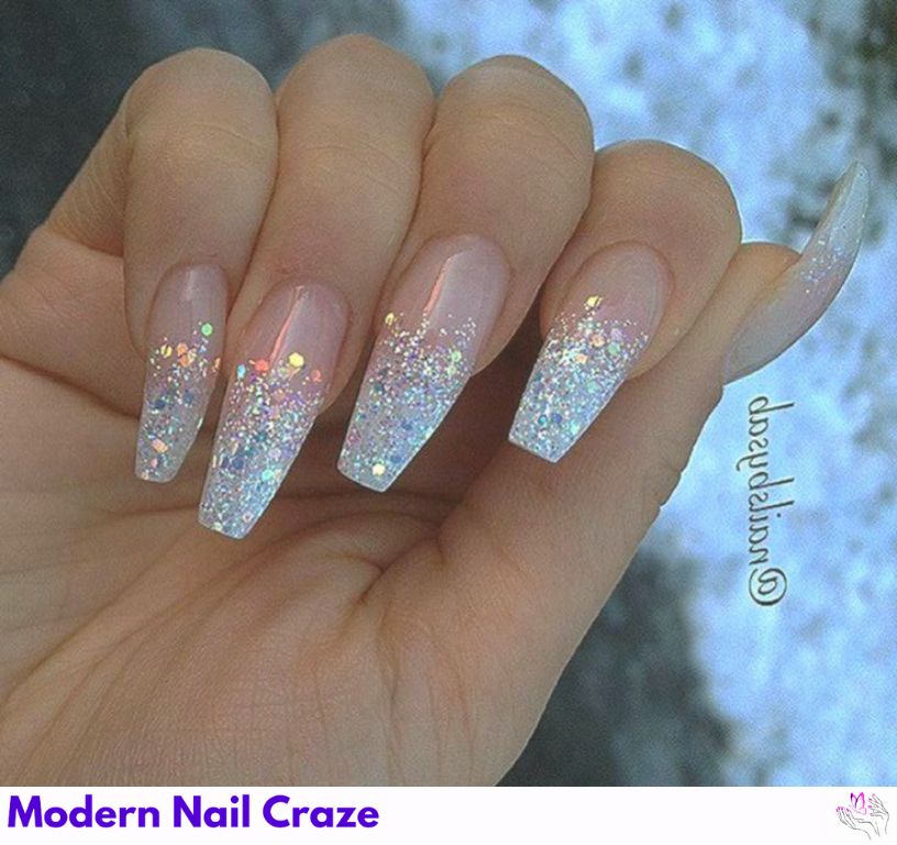 Soft nude nails fading into red glitter tips in an ombre style for Valentine’s glam.
