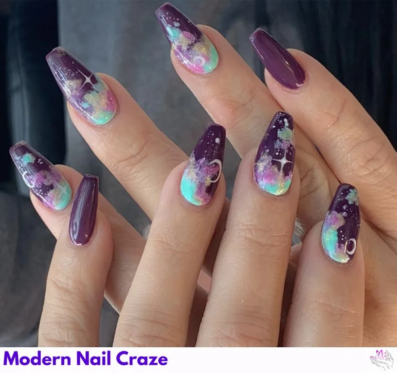Hand-painted nail art featuring stars, moons, and constellations on navy blue polish