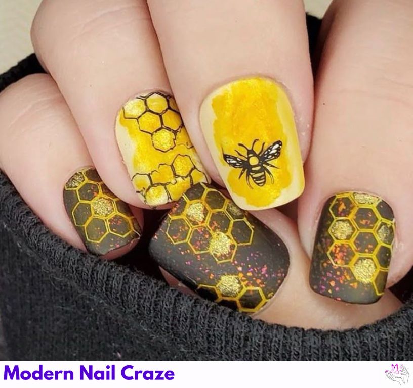 Golden honeycomb nail accents with 3D bee graphics.