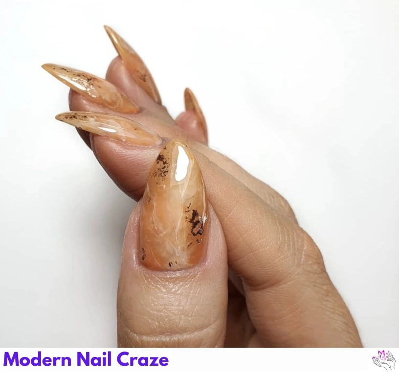 Light orange and gold marble nails — elegant fall design for long nails.